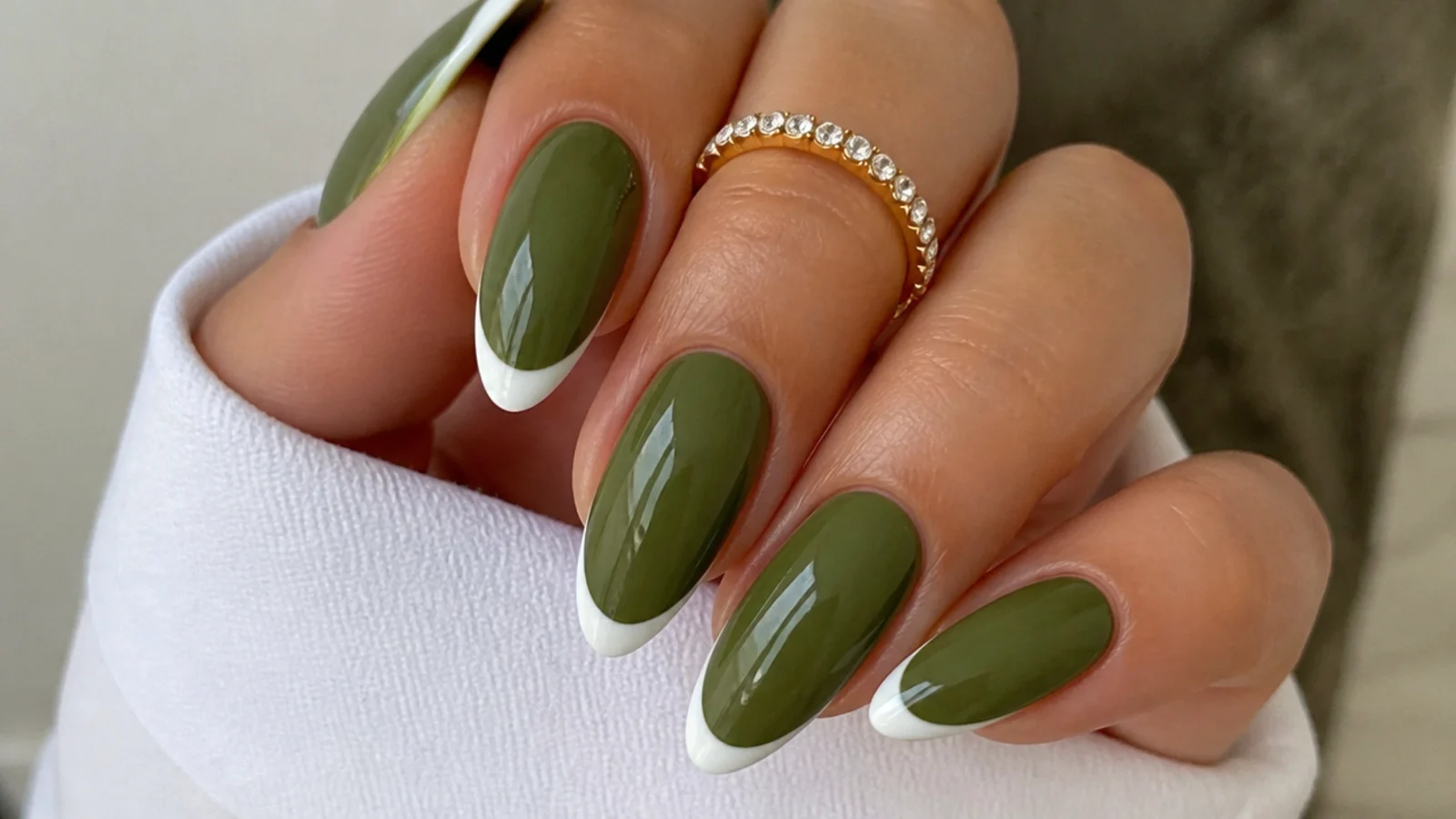 Olive green acrylic nails with crisp white french tips