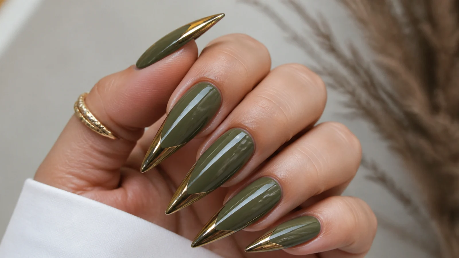 Long olive green stiletto acrylic nails with chrome-dipped tips