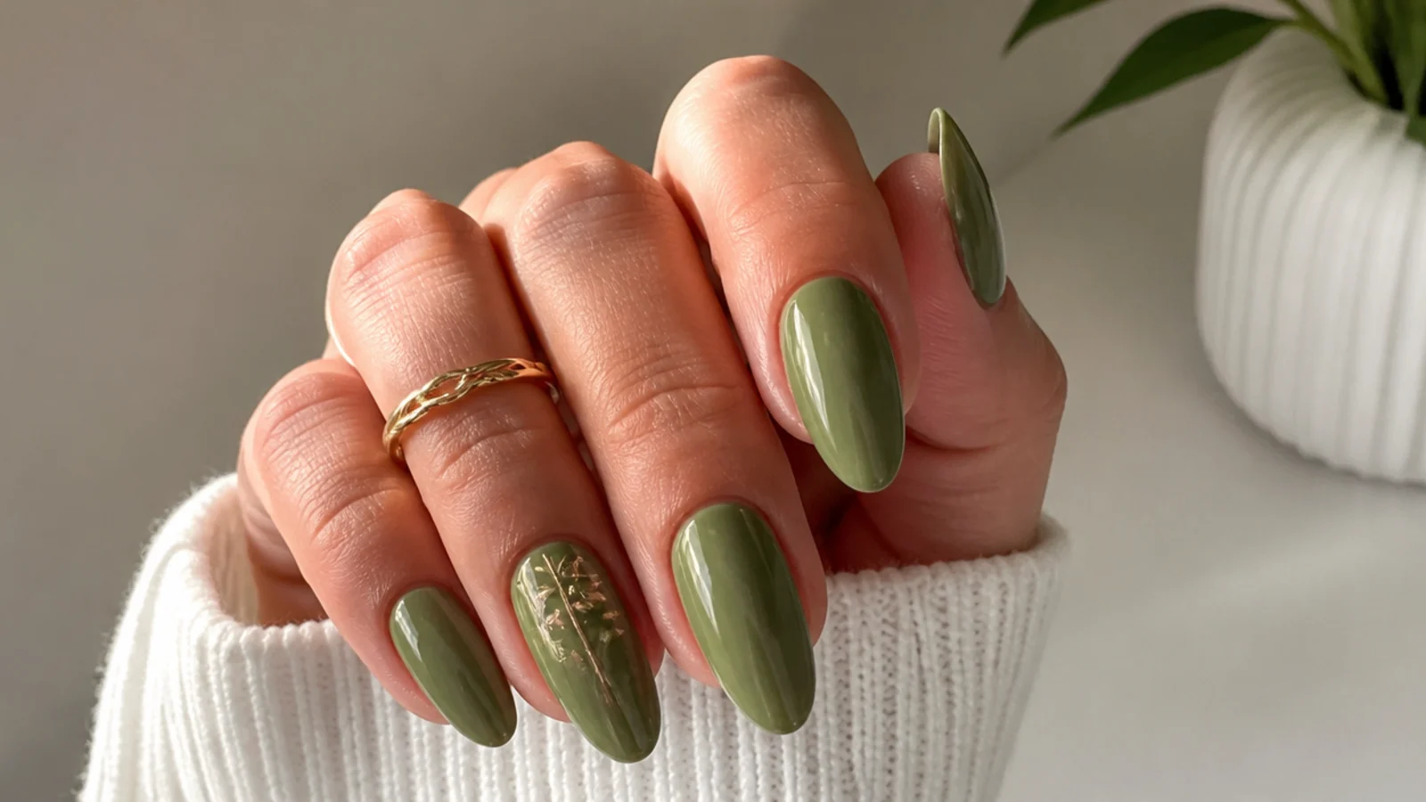 Earthy olive green acrylic nails in an almond shape with a glossy finish