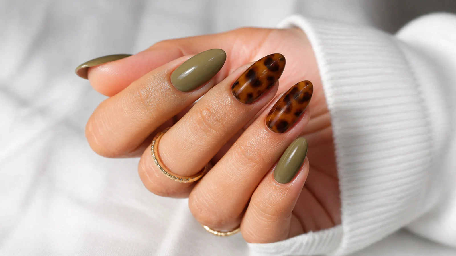 Warm olive almond nails with brown tortoiseshell accent nails