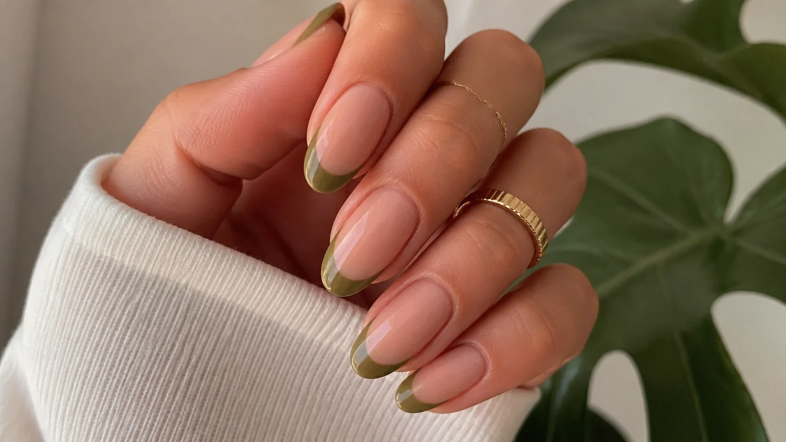 Sheer nude almond nails with warm olive green french tips