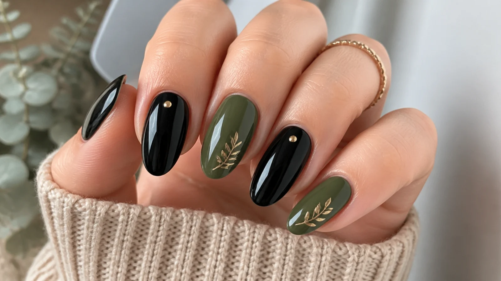 Alternating warm olive and glossy black almond nails