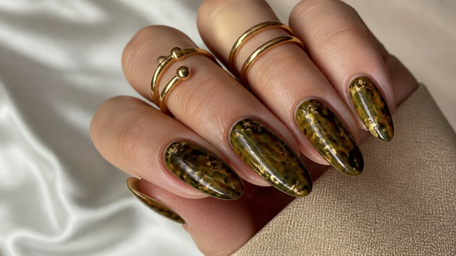 Olive green tortoiseshell nails with amber, brown and gold spots