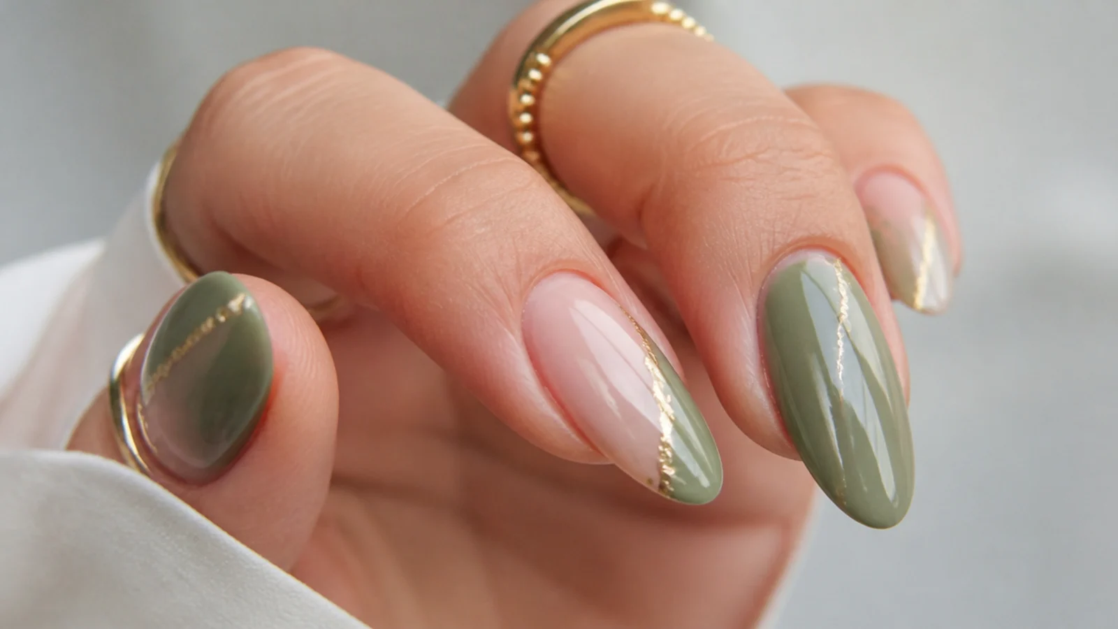 Olive green and pink nails with thin gold foil accent lines