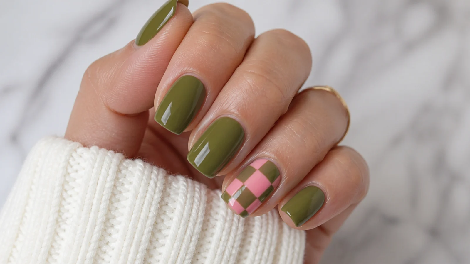 Olive green and pink checkerboard accent nail with solid nails alongside