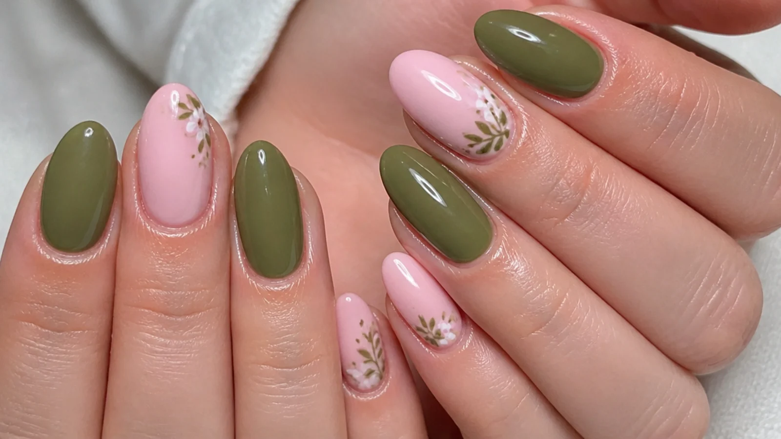 A well-sealed olive green and pink gel manicure with cuticle oil