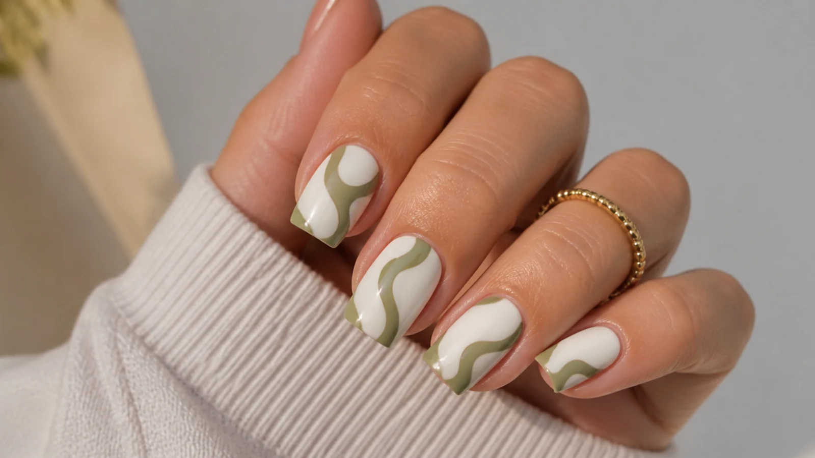 Retro olive green swirl lines over a white base on square nails