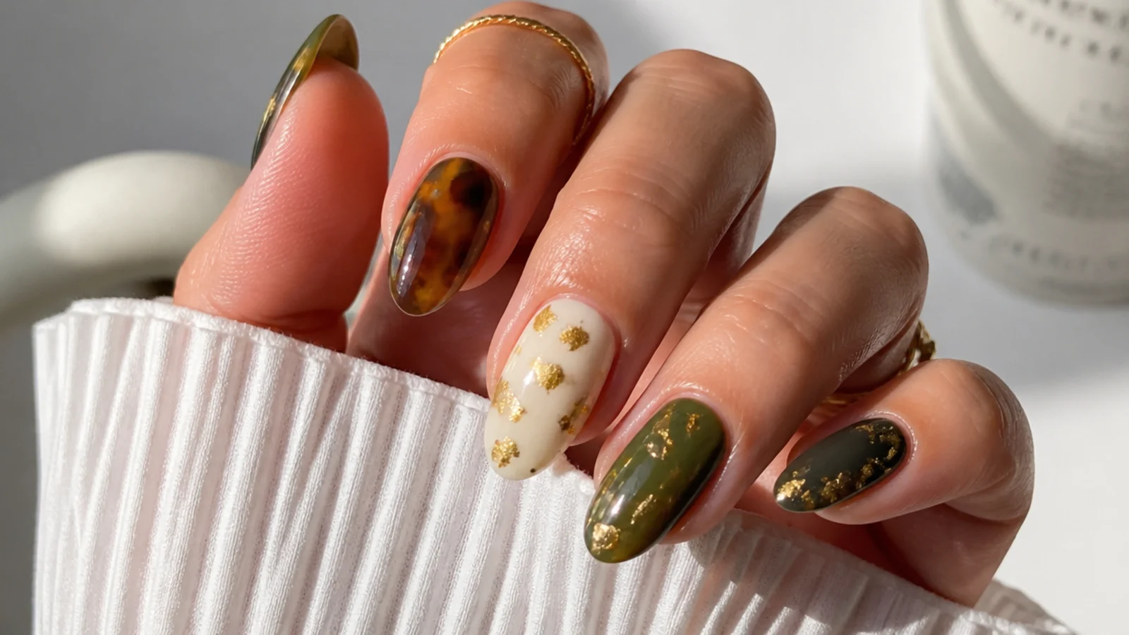 Olive green tortoiseshell nails with cream white accent and gold flecks