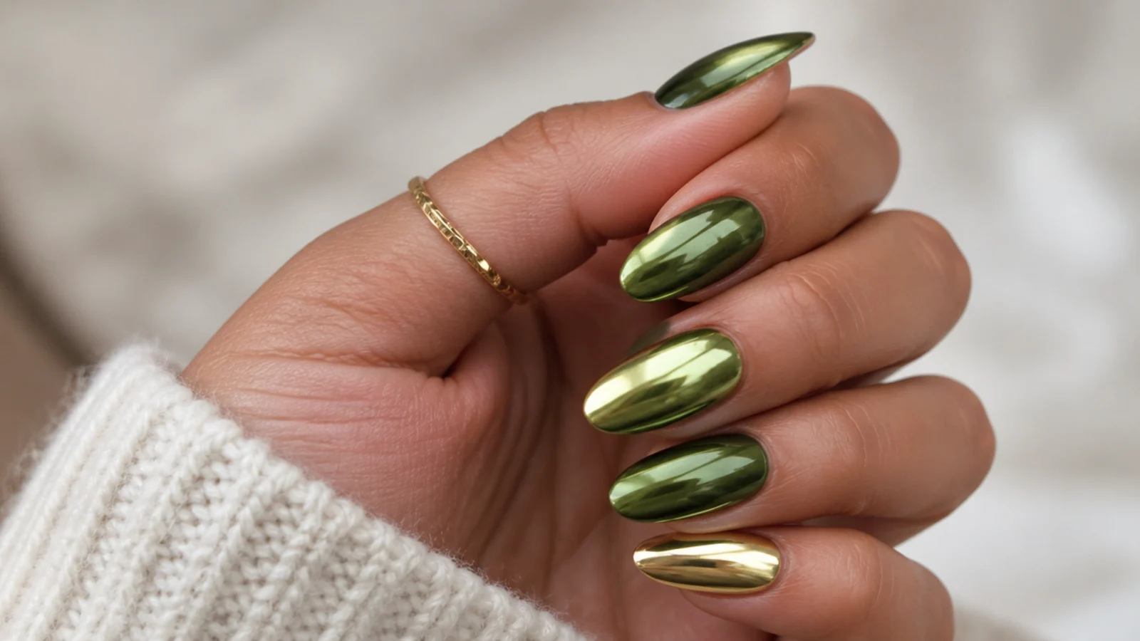 Olive green chrome nails with gold chrome accent nails on a warm hand