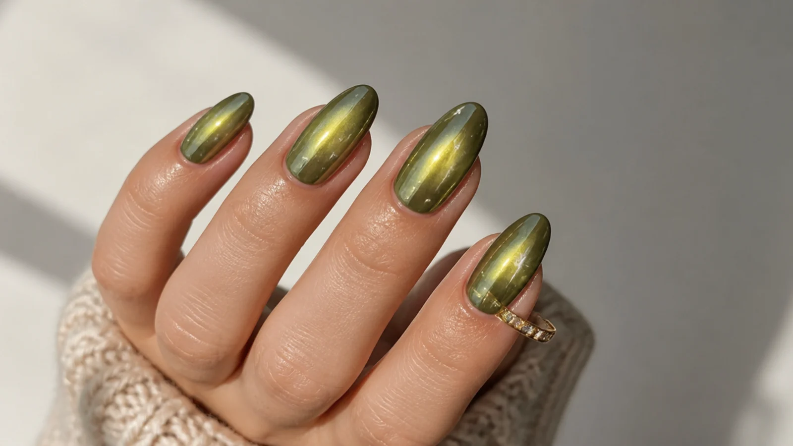 Olive green aura chrome nails with a soft glowing halo of light in the center
