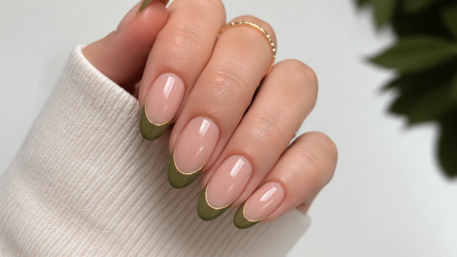 Nude nails with olive green french tips lined in thin gold