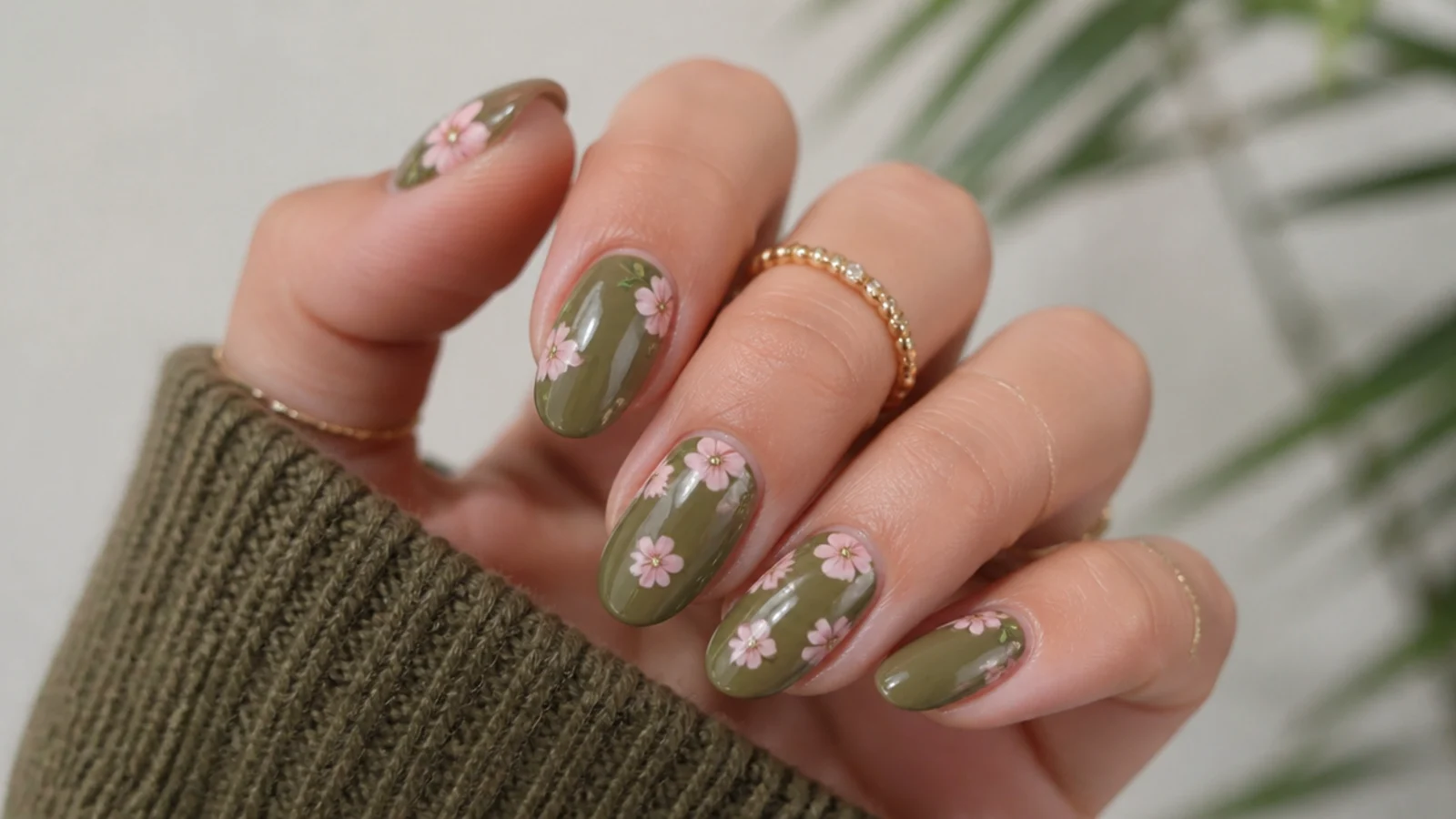 Olive green nails with tiny soft pink hand-painted flowers
