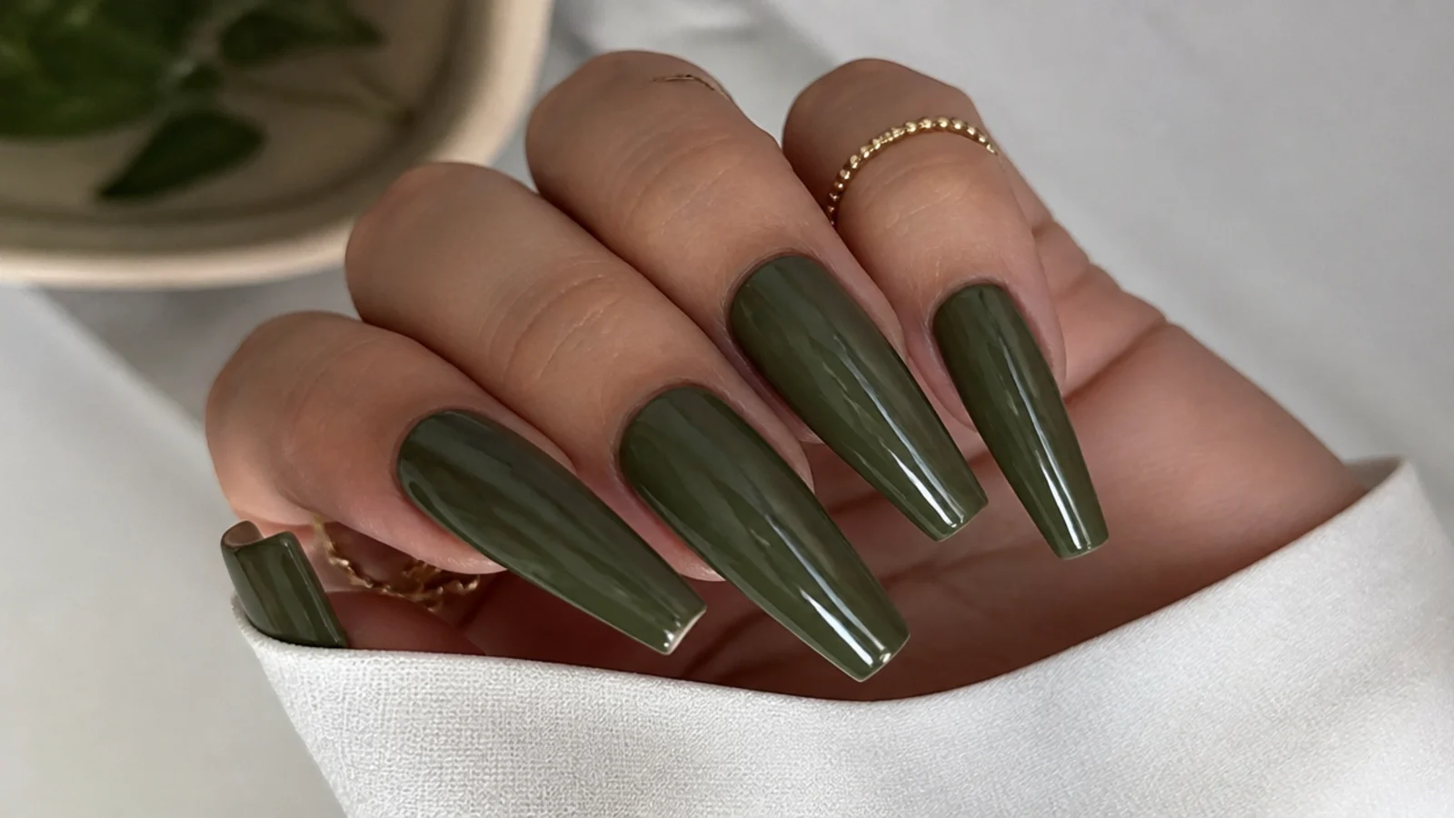 Long olive green coffin nails with a glossy finish