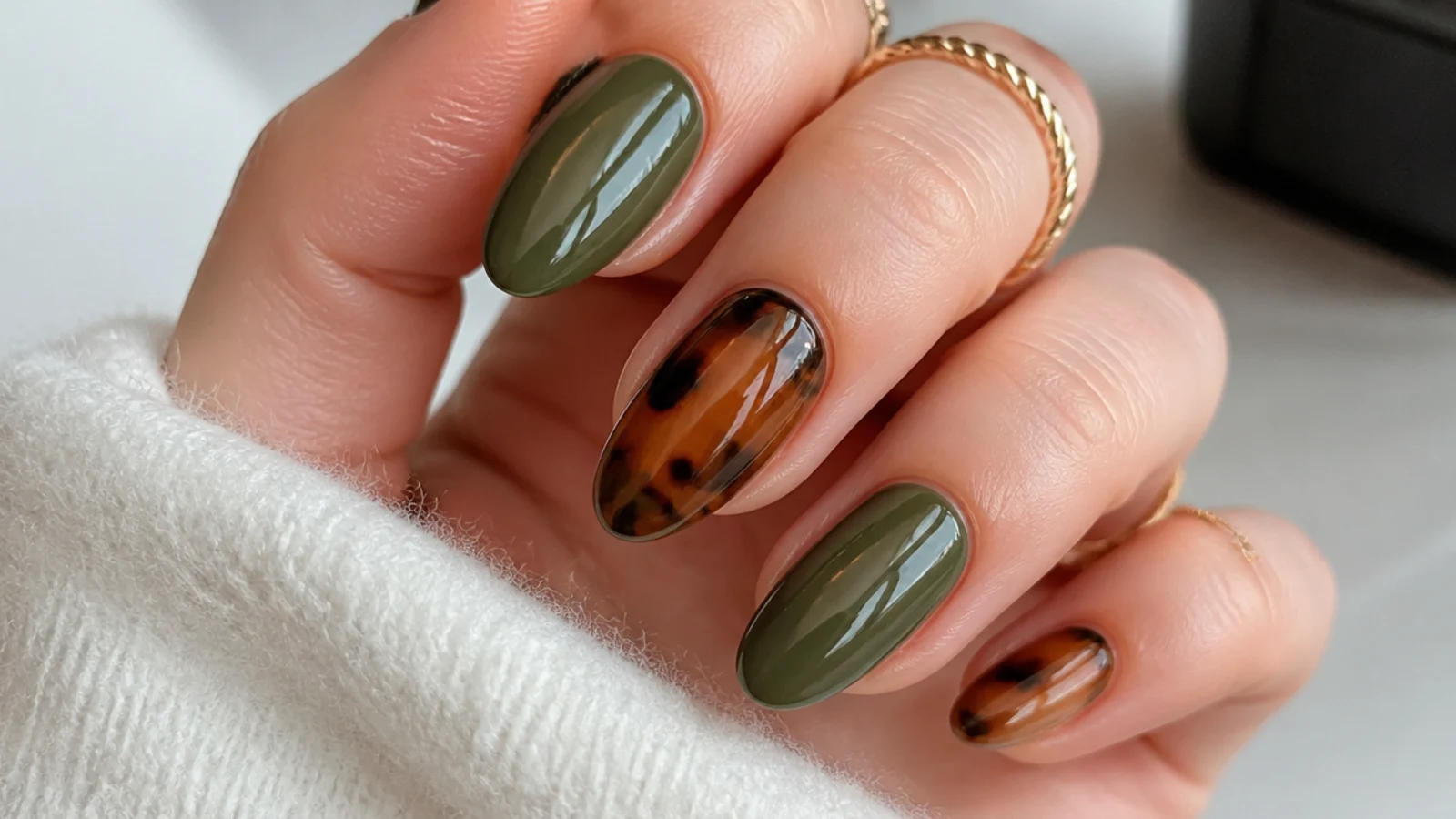 Olive green and amber tortoiseshell nails with translucent depth