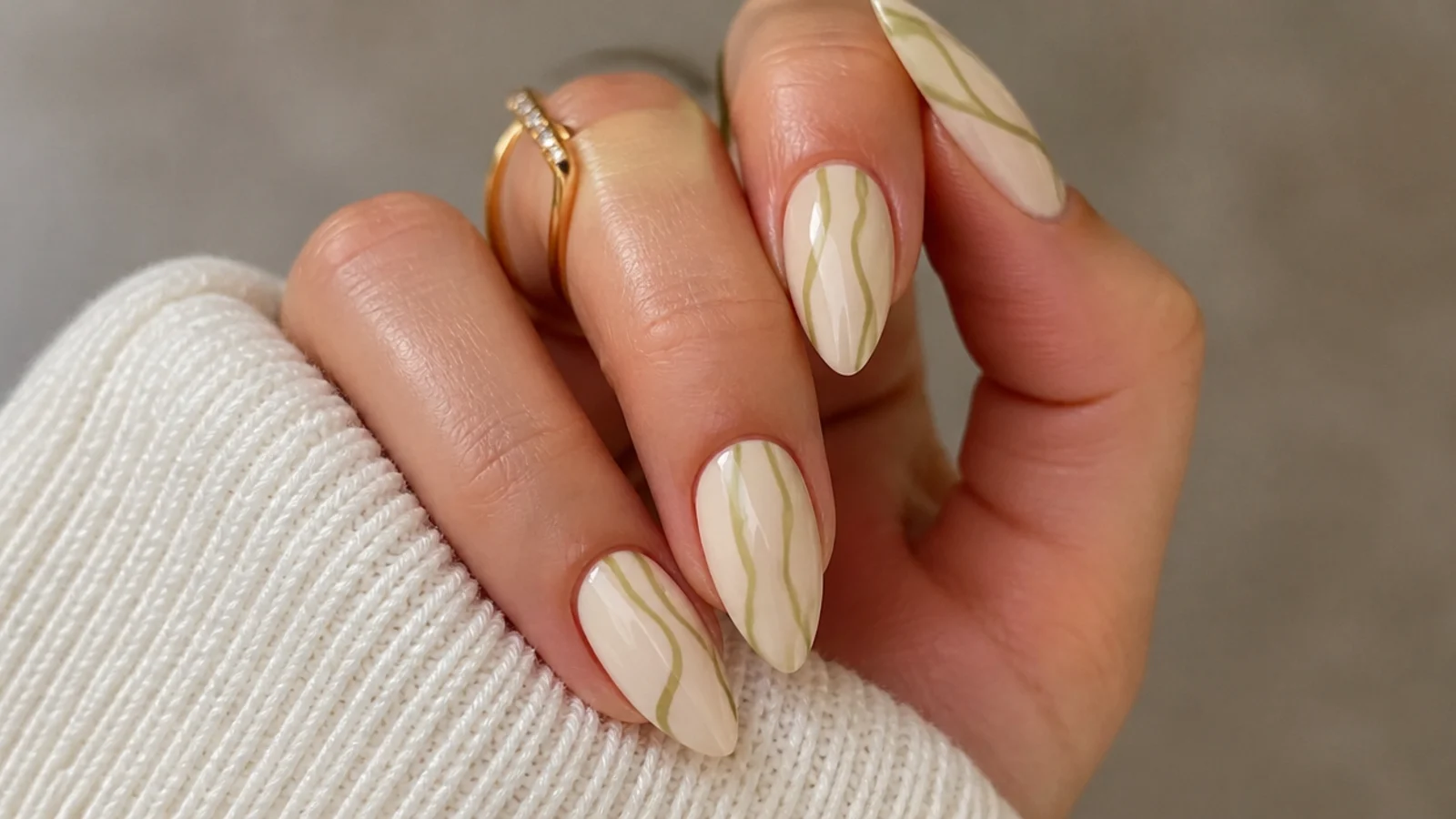 Cream nails with olive green abstract swirl lines