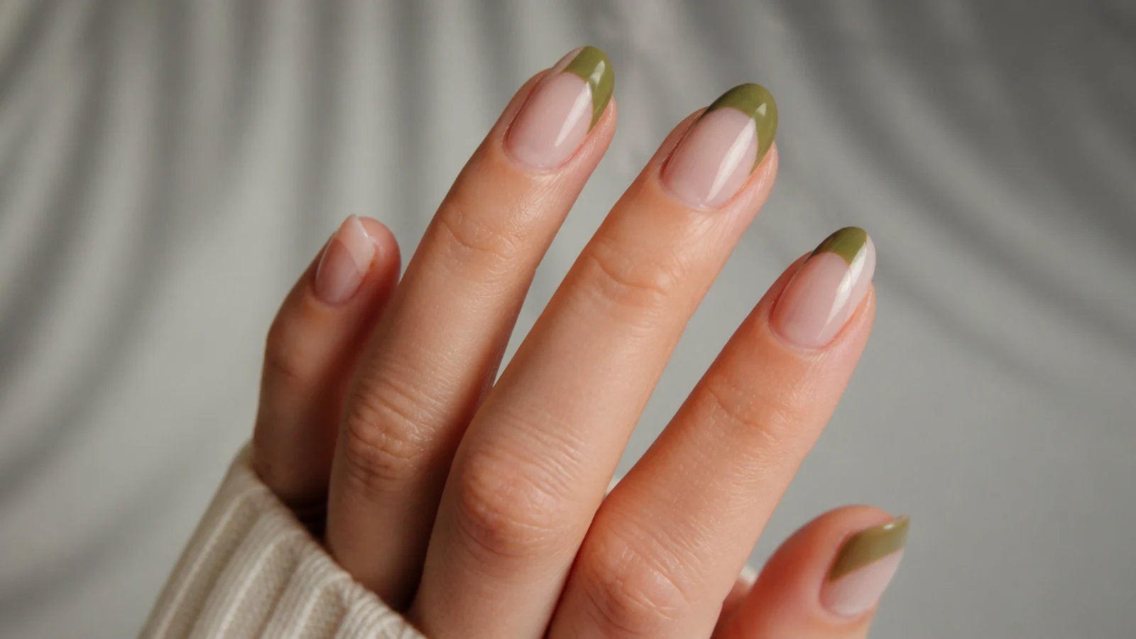 Clear nails with partial olive green negative-space shapes