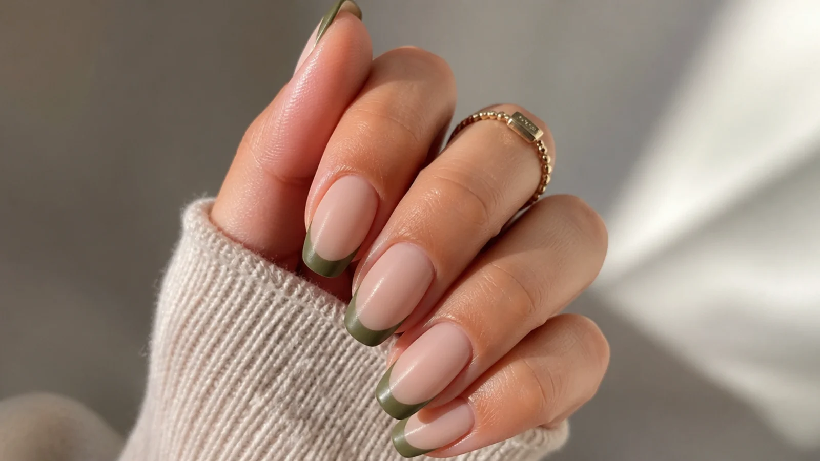 Matte muted olive green french tips over a soft nude base