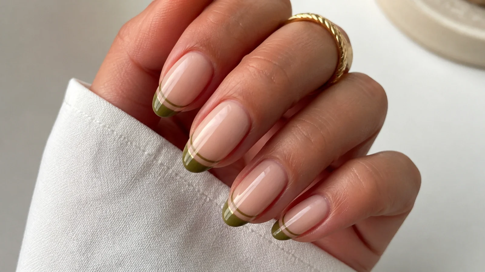 Olive green french tips with a thin second olive line below on nude nails