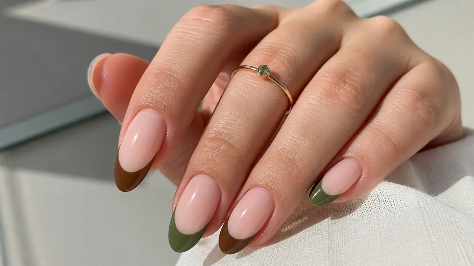 French tips mixing olive green and warm brown over nude nails
