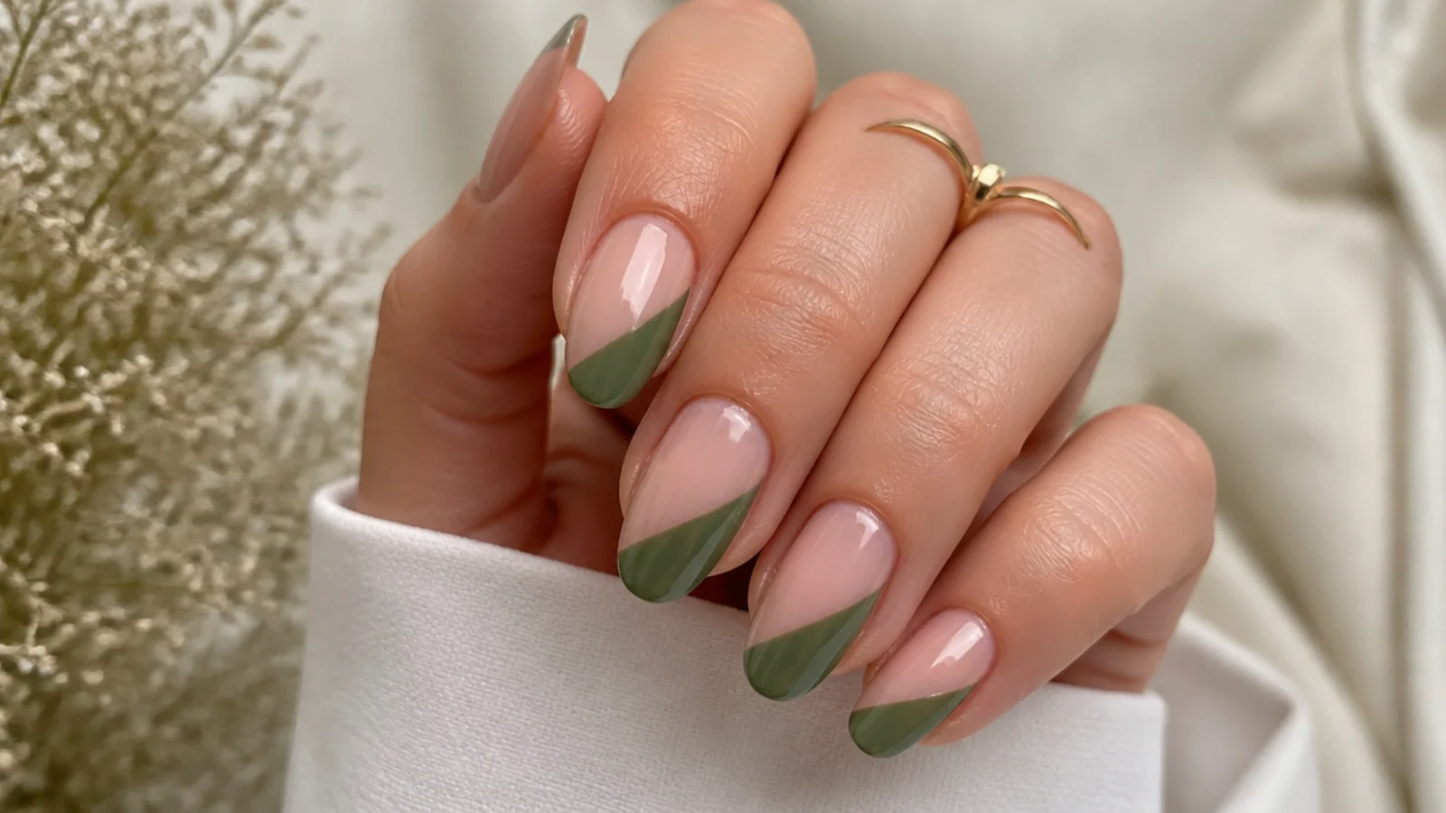 Olive green french tips painted on a slanted diagonal over nude nails