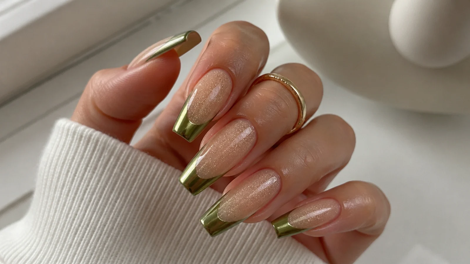 Glossy olive chrome tips paired with a chrome-dusted nude base on coffin nails