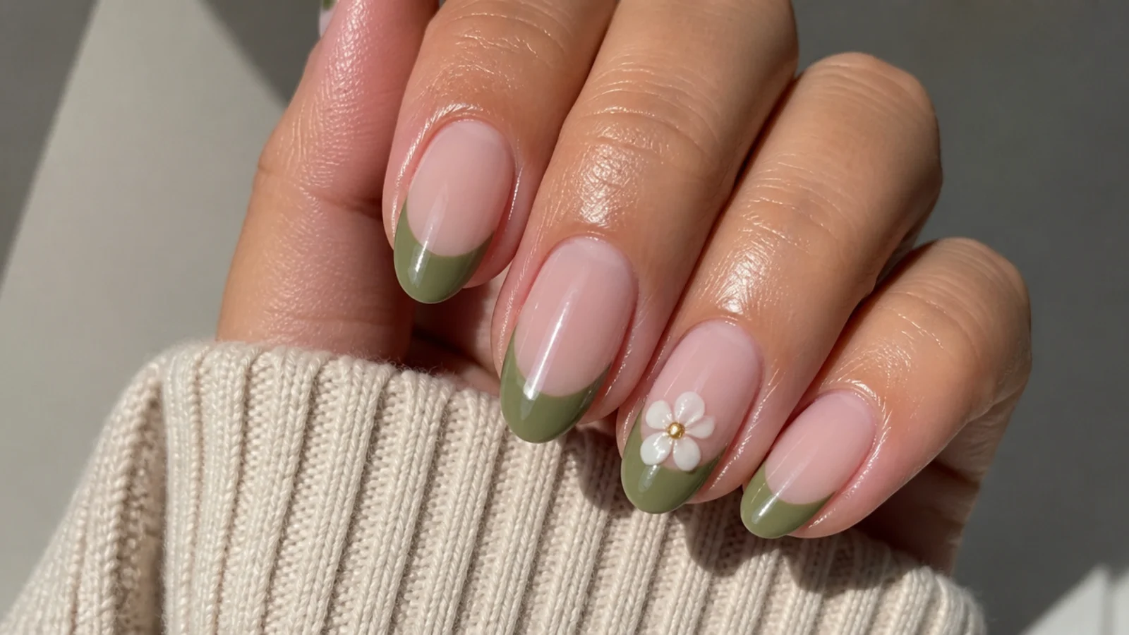 A well-sealed olive green french tip manicure with cuticle oil