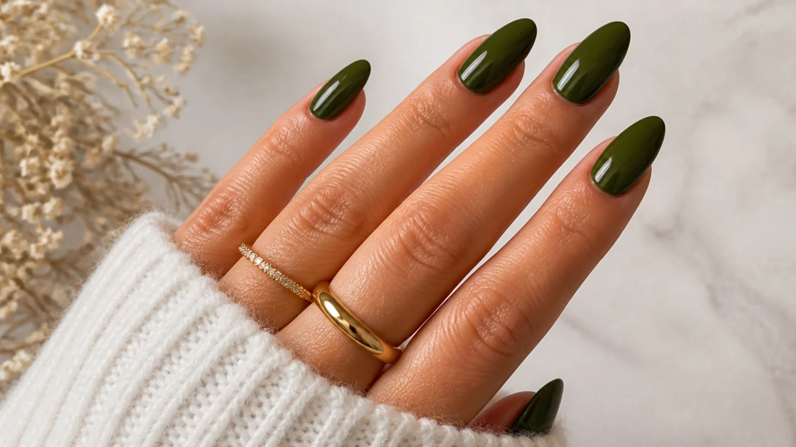 Deep saturated dark olive green nails on a long almond shape