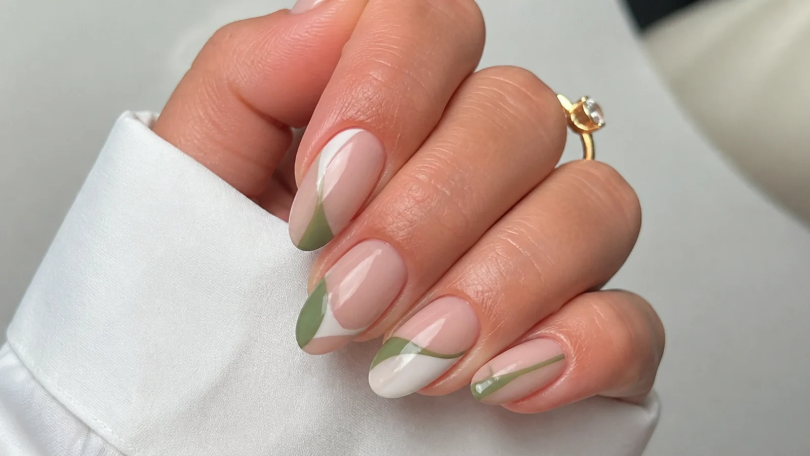 Olive green and white negative space geometric nails on a nude base