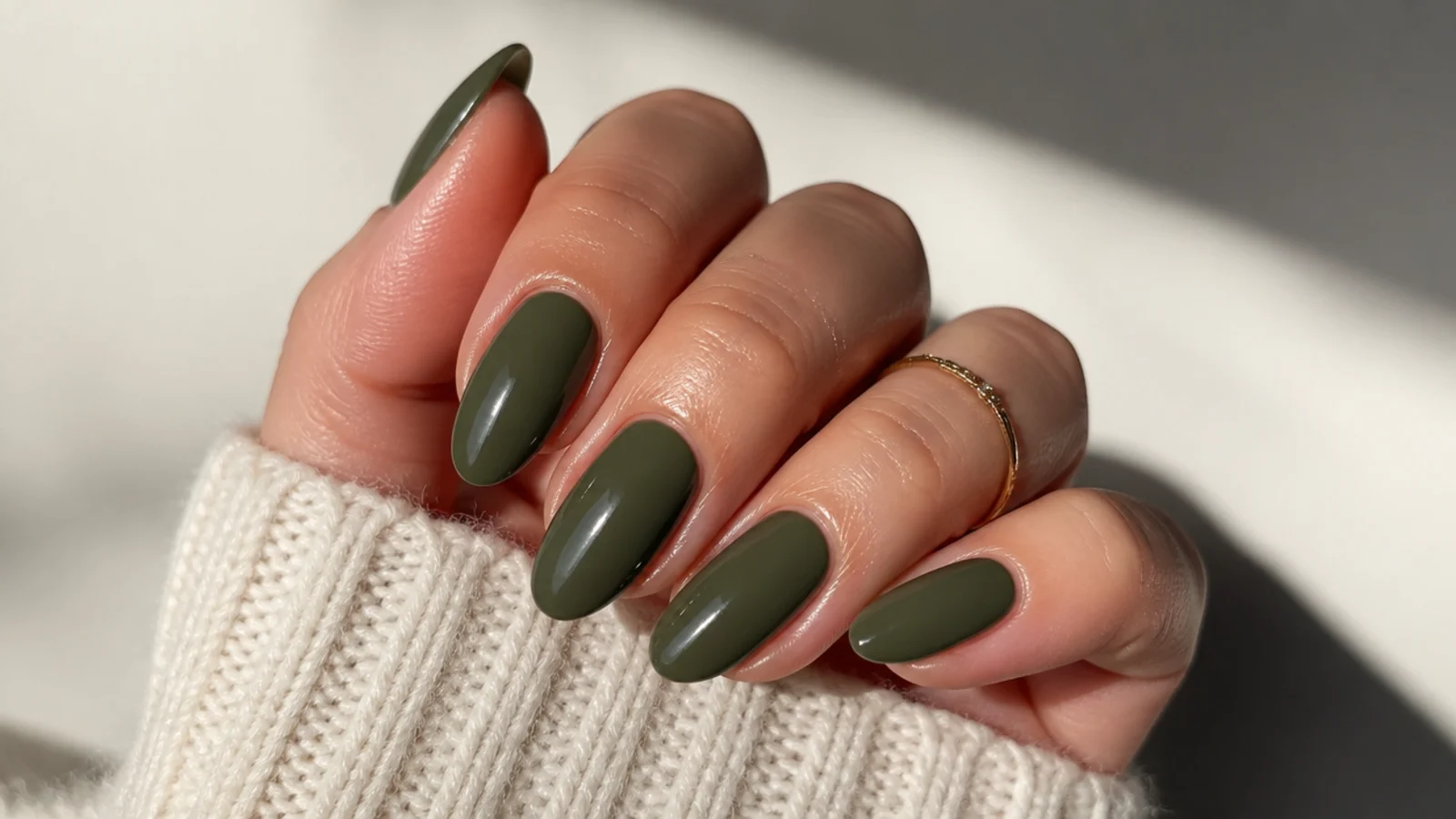 Long almond nails in a rich saturated deep olive green with high gloss