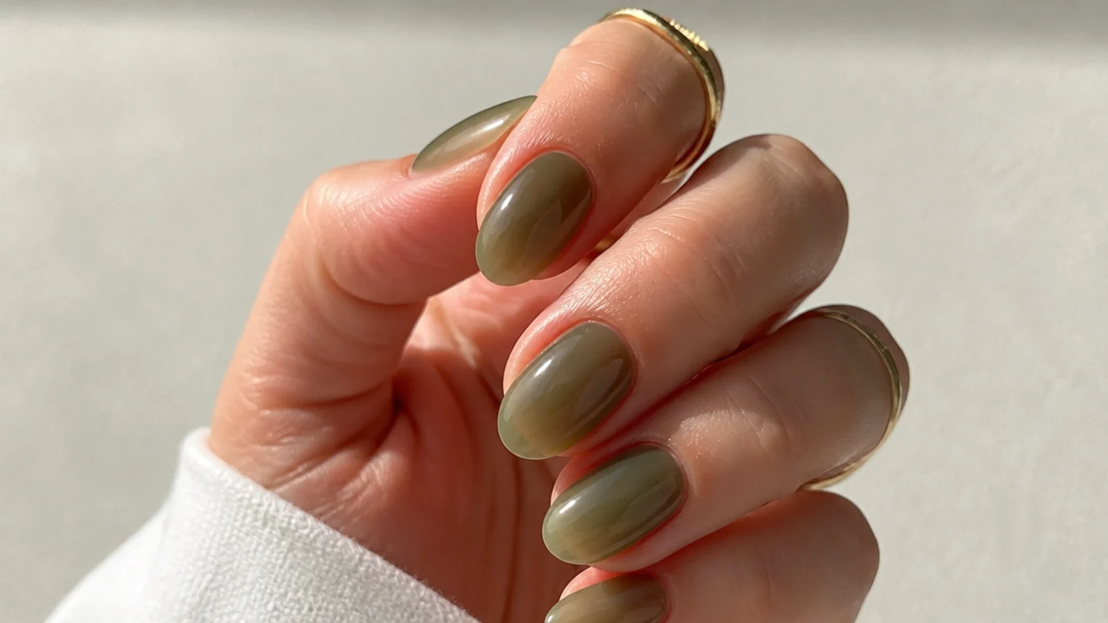 Short almond nails in a sheer translucent jelly olive green