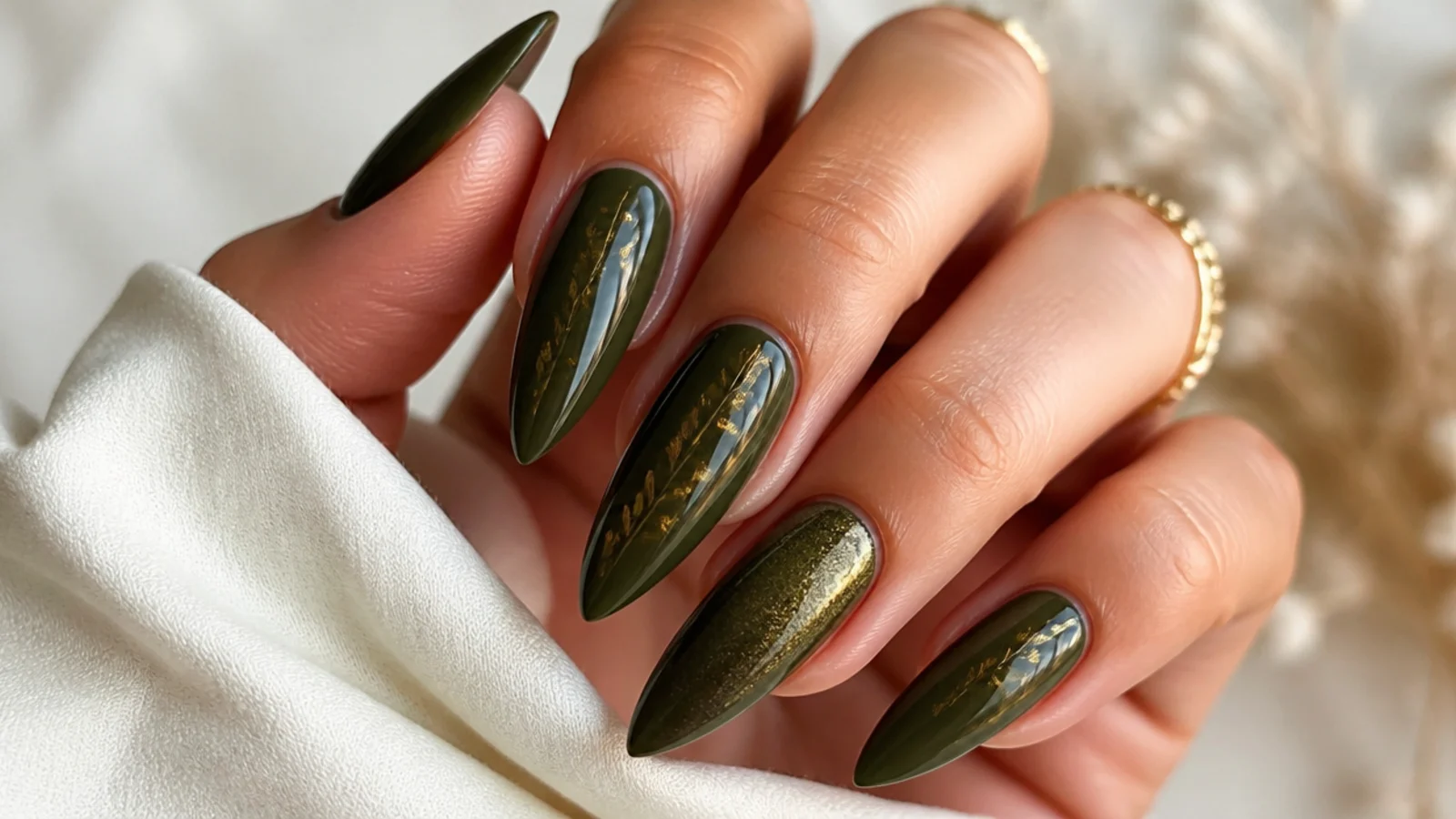 Deep dark olive green nails on a long stiletto shape