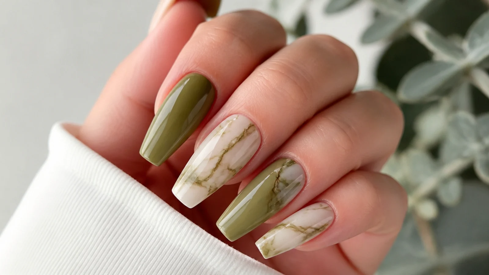 Olive green and cream marble nails with soft veining on a coffin shape