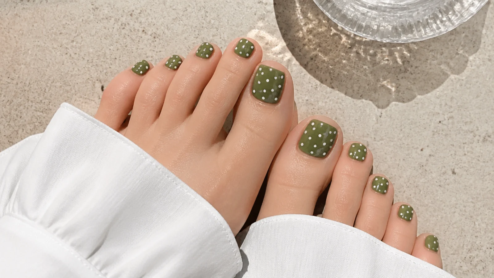 Olive green toe nails with small white polka dots