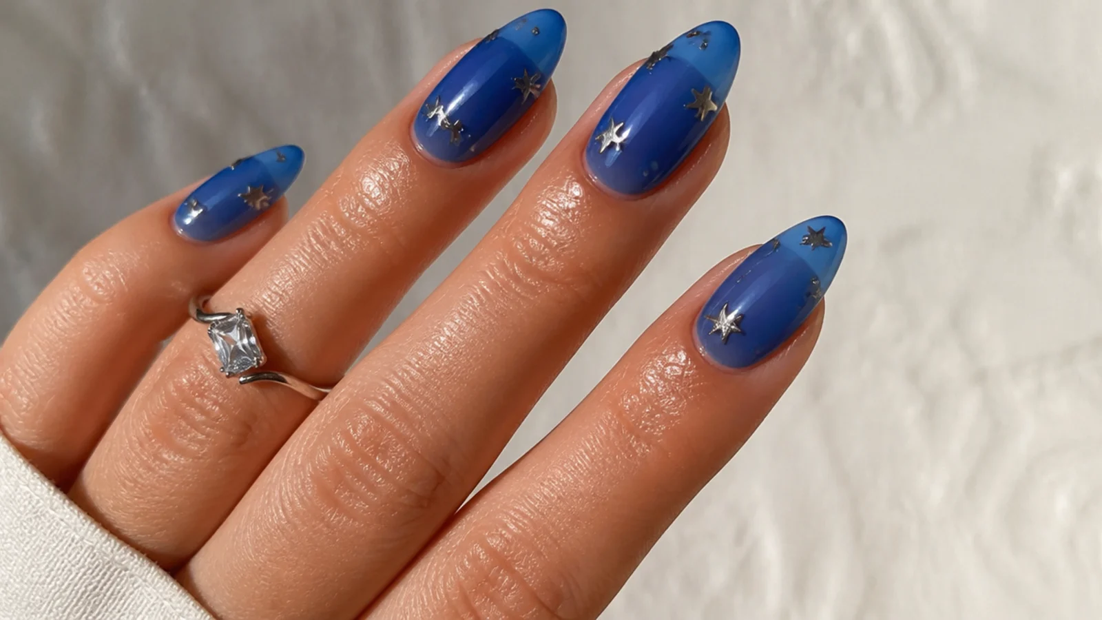 Translucent royal blue jelly nails with a glazed sheer finish