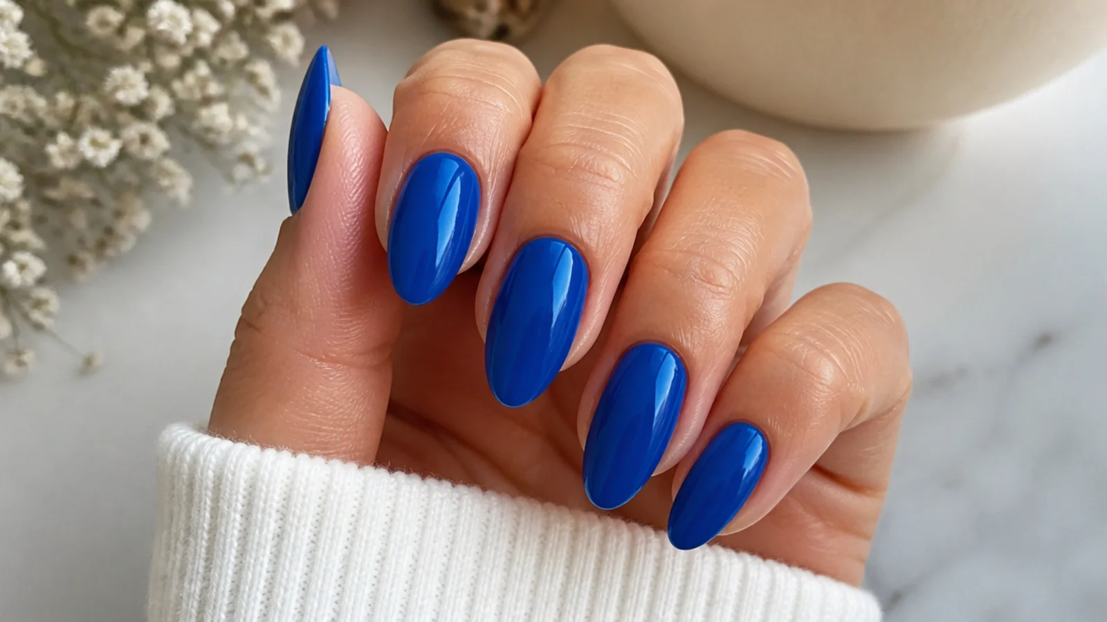 Medium royal blue almond nails with a glossy finish