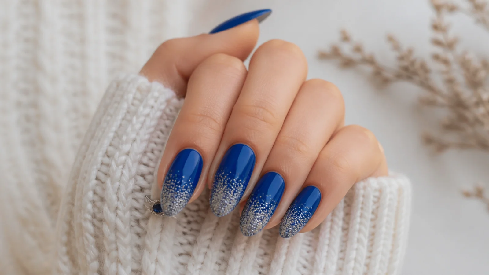 Royal blue nails with silver glitter gradient tips fading to solid blue