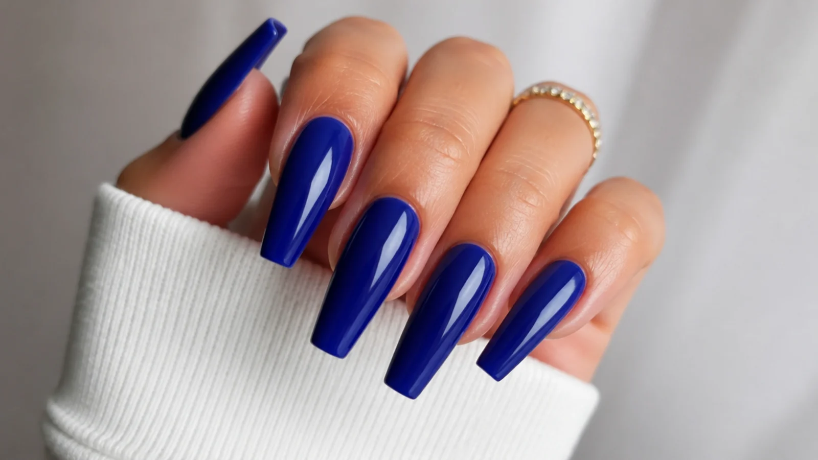 Long royal blue coffin nails with a glossy finish