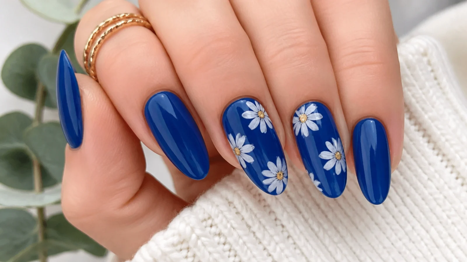 Royal blue nails with delicate hand-painted white daisy florals