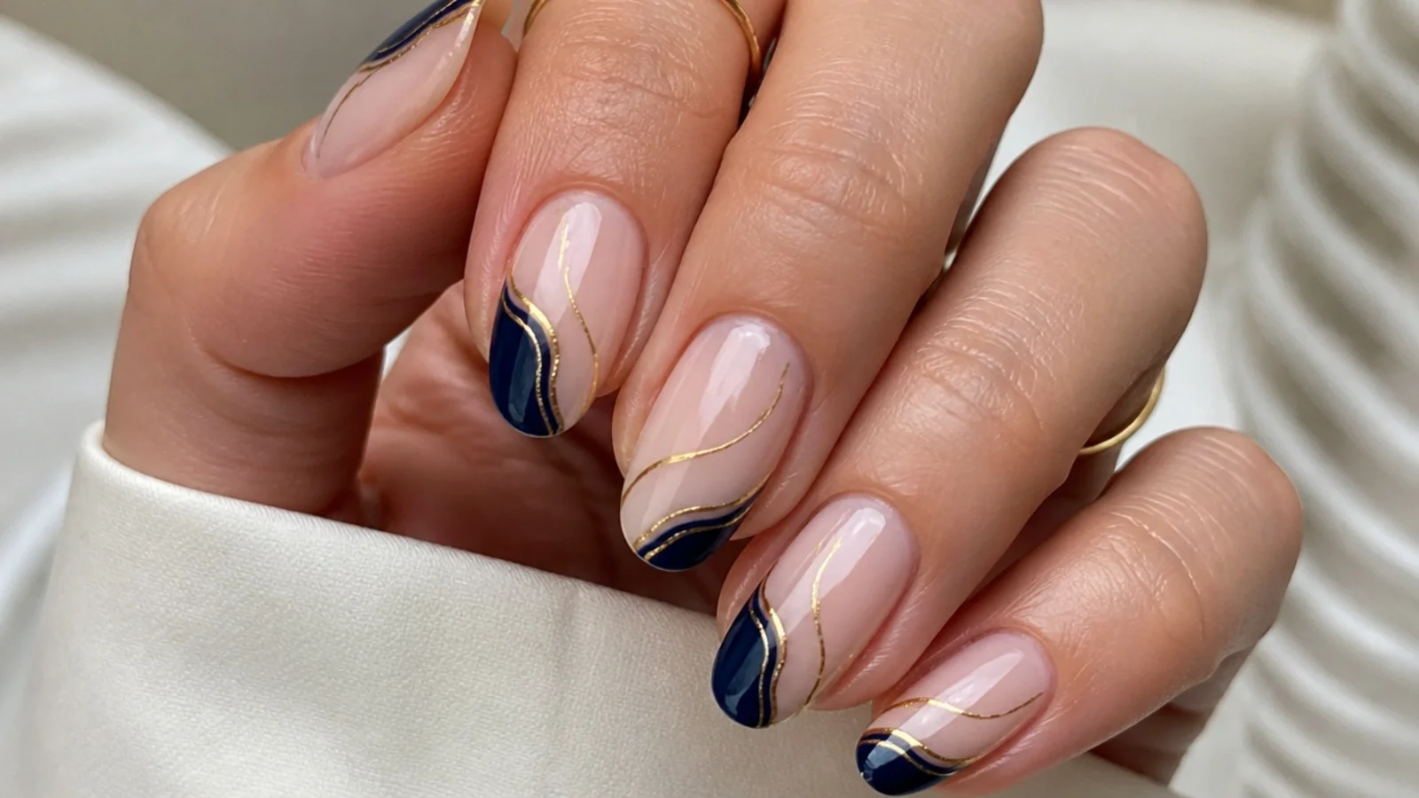 Nude nails with royal blue and gold abstract line art