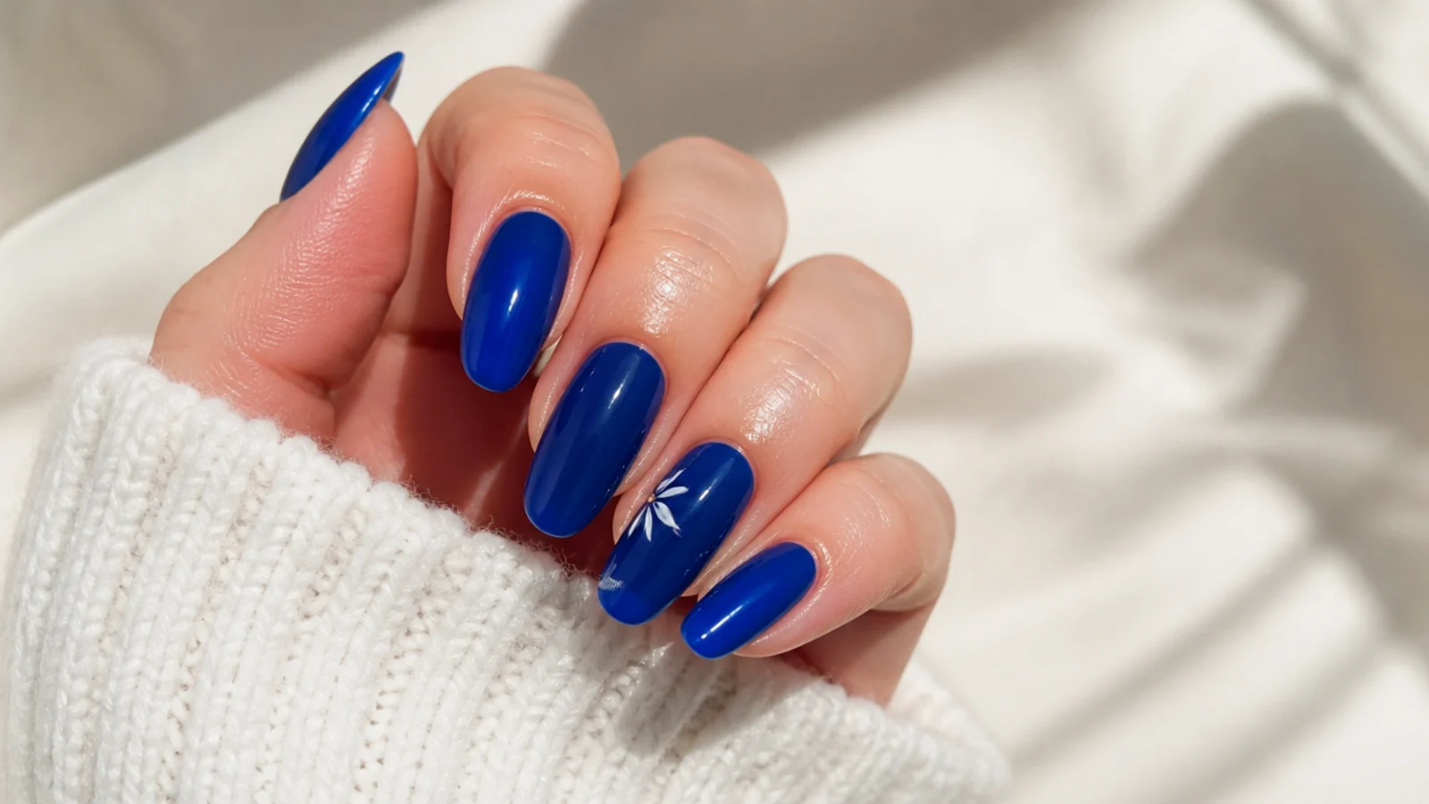 A well-sealed royal blue gel manicure with cuticle oil for longevity
