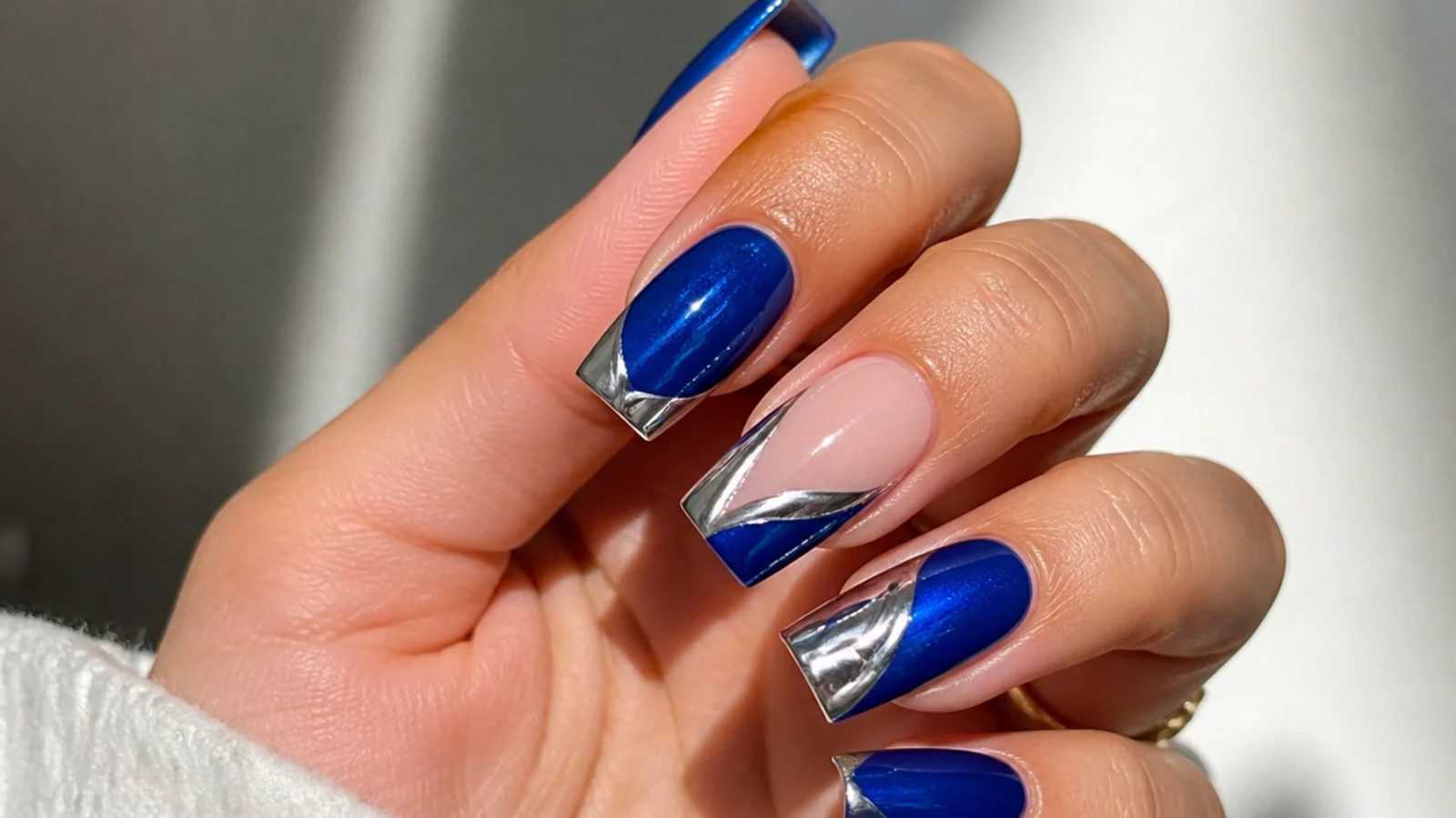 Royal blue acrylic nails with silver chrome accents in a square shape