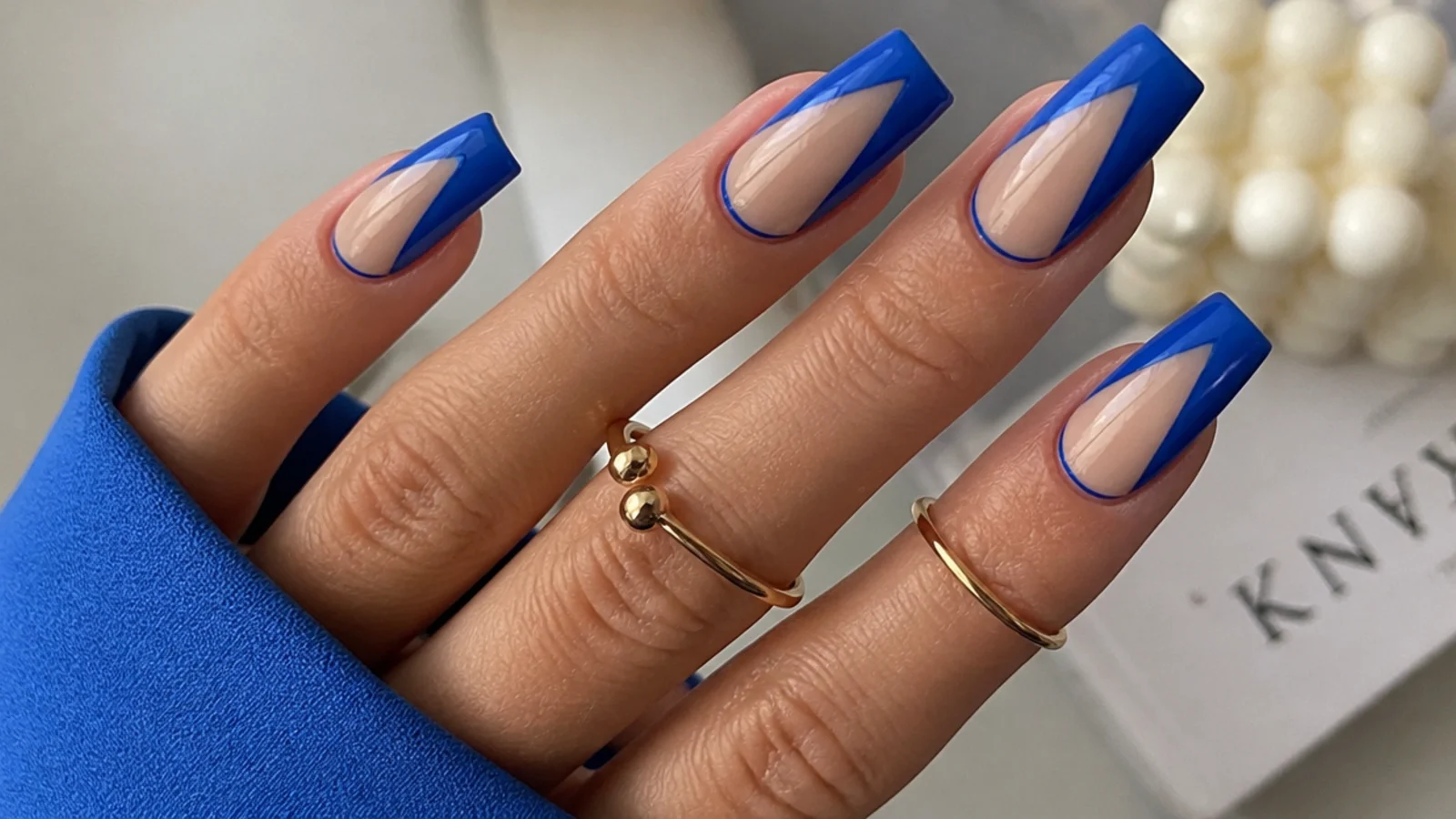 Royal blue acrylic nails with clear nude negative space on square nails