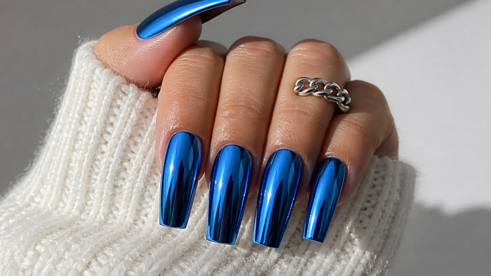 Royal blue chrome mirror acrylic nails with a metallic finish on coffin nails