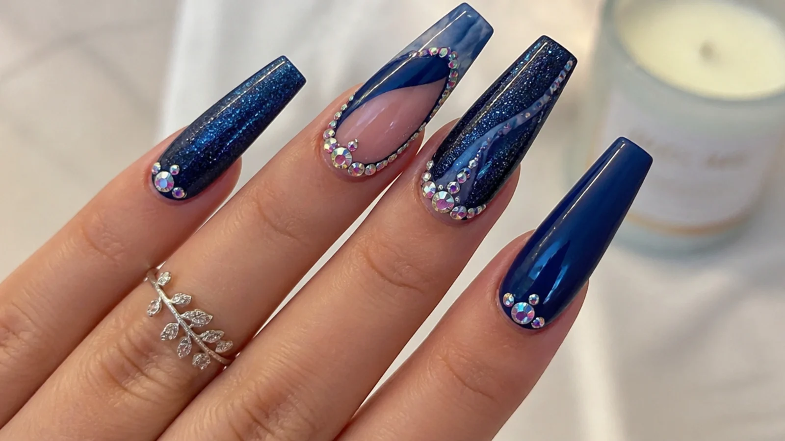 Long royal blue acrylic nails with rhinestones and glitter for prom on coffin nails