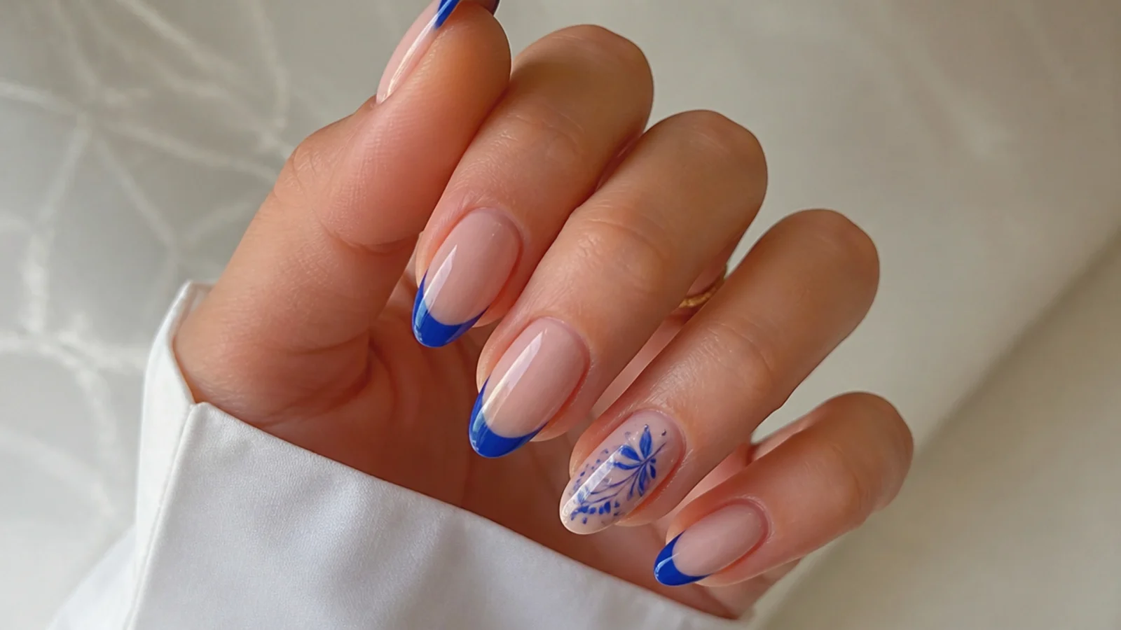 Soft royal blue french acrylic nails with a single blue accent for a wedding on almond nails