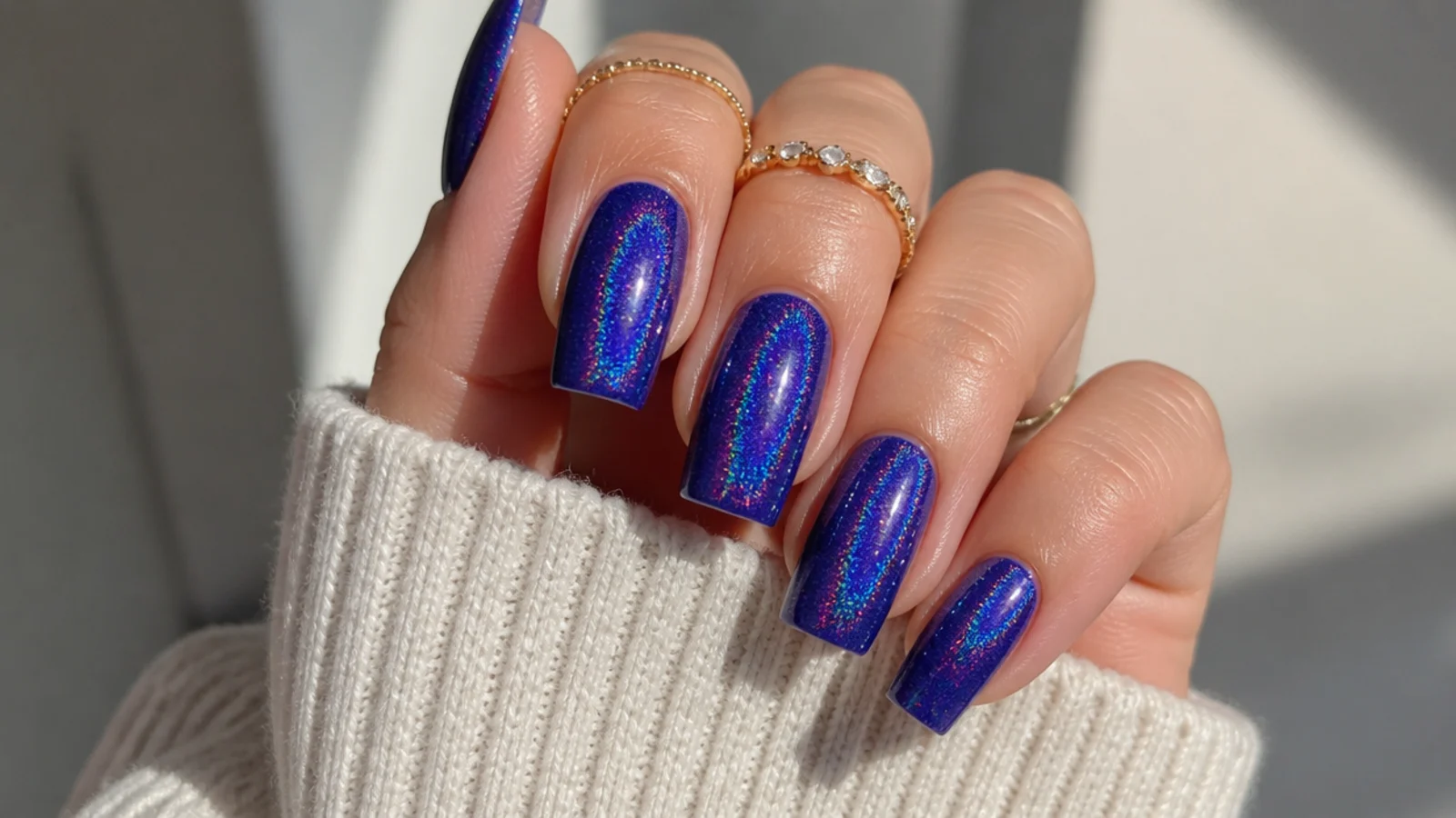 Royal blue holographic acrylic nails with rainbow shimmer on square nails