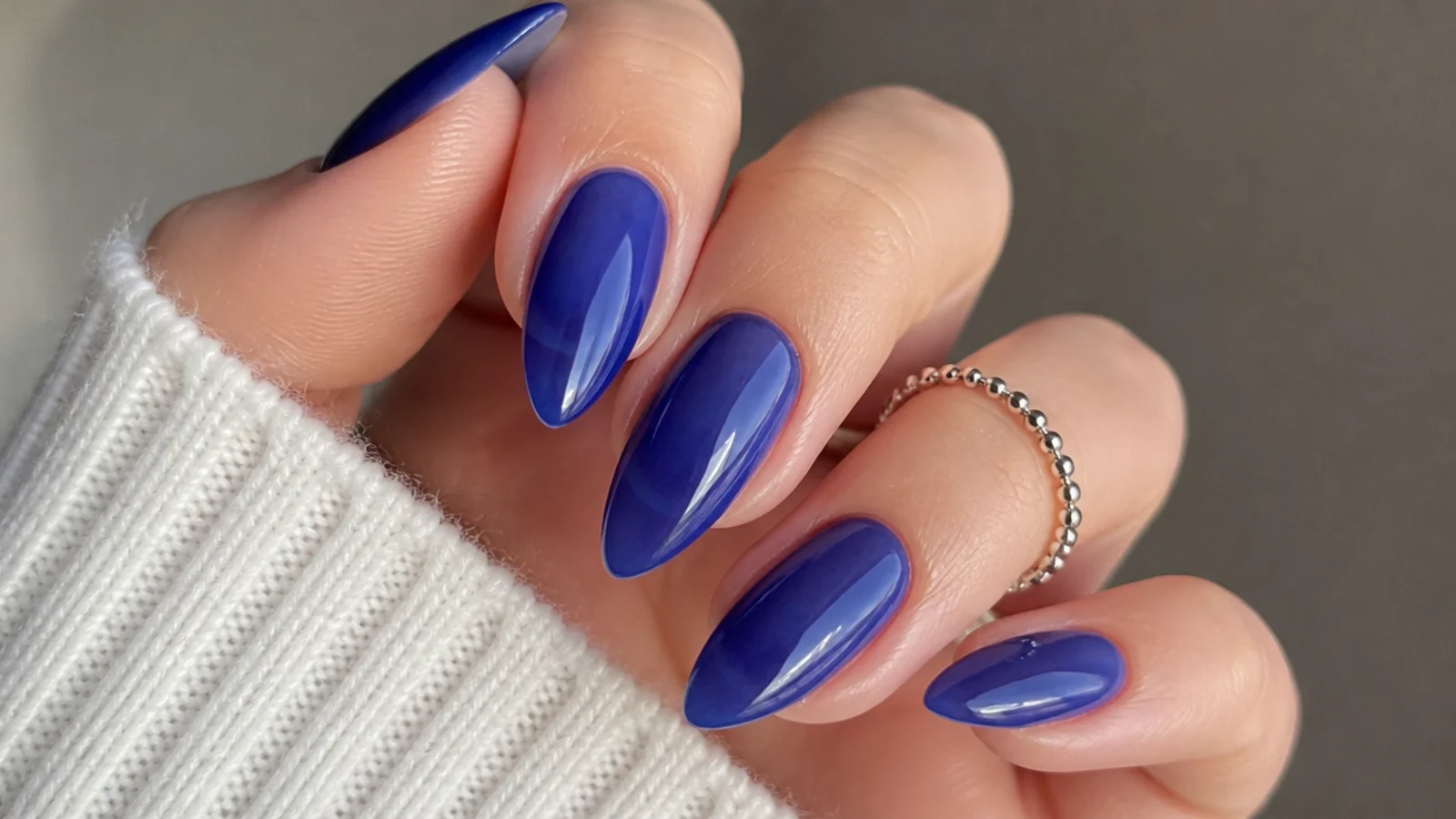 Translucent cobalt jelly almond nails with the nail showing through