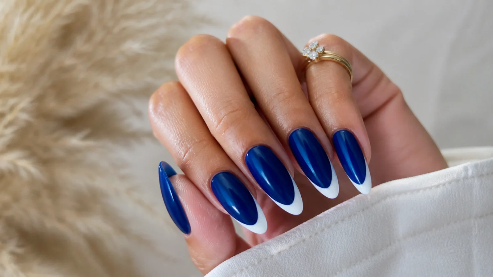 Royal blue almond nails with a crisp white french tip accent