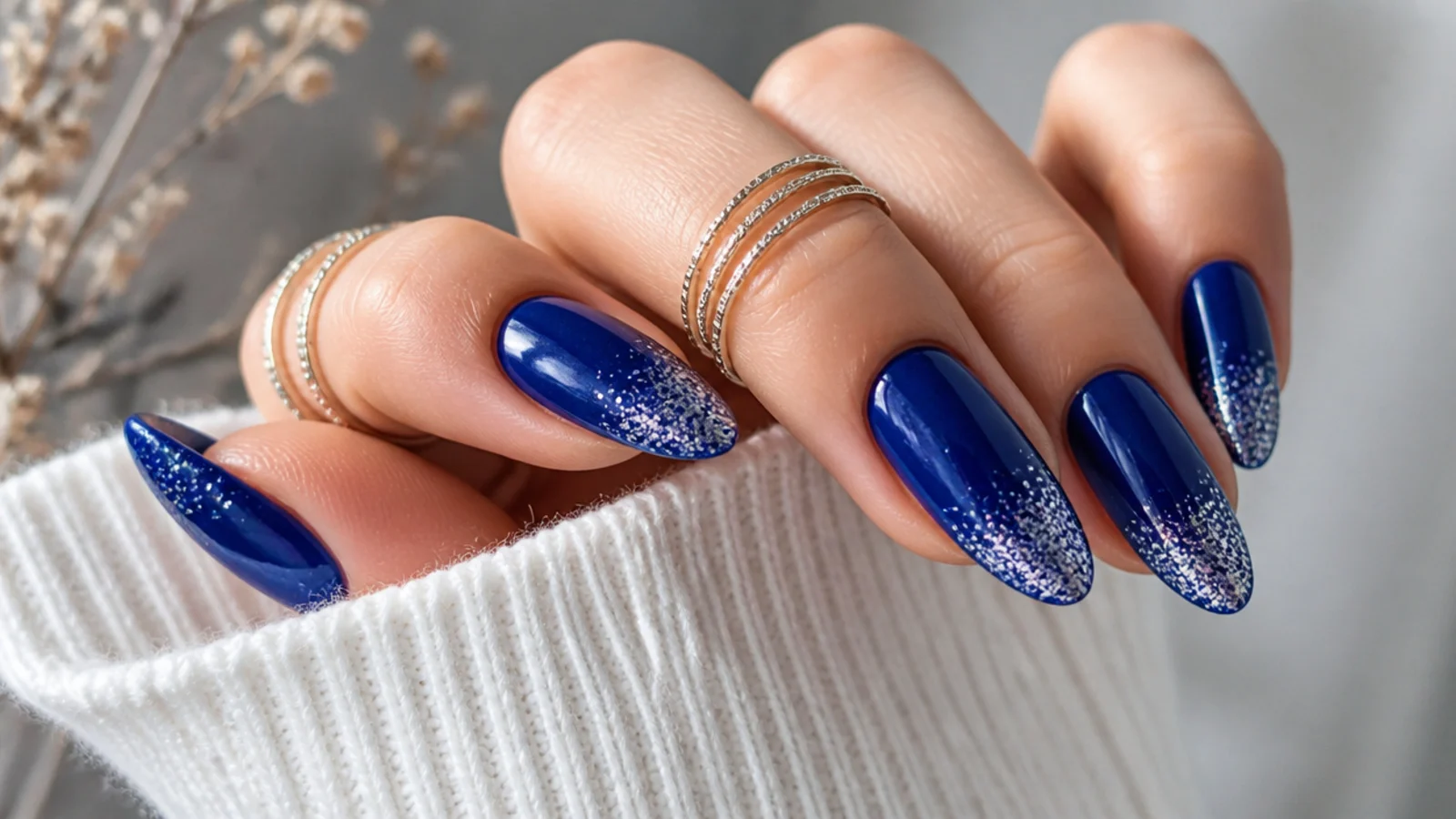 Royal blue almond nails with sparkling silver glitter gradient tips