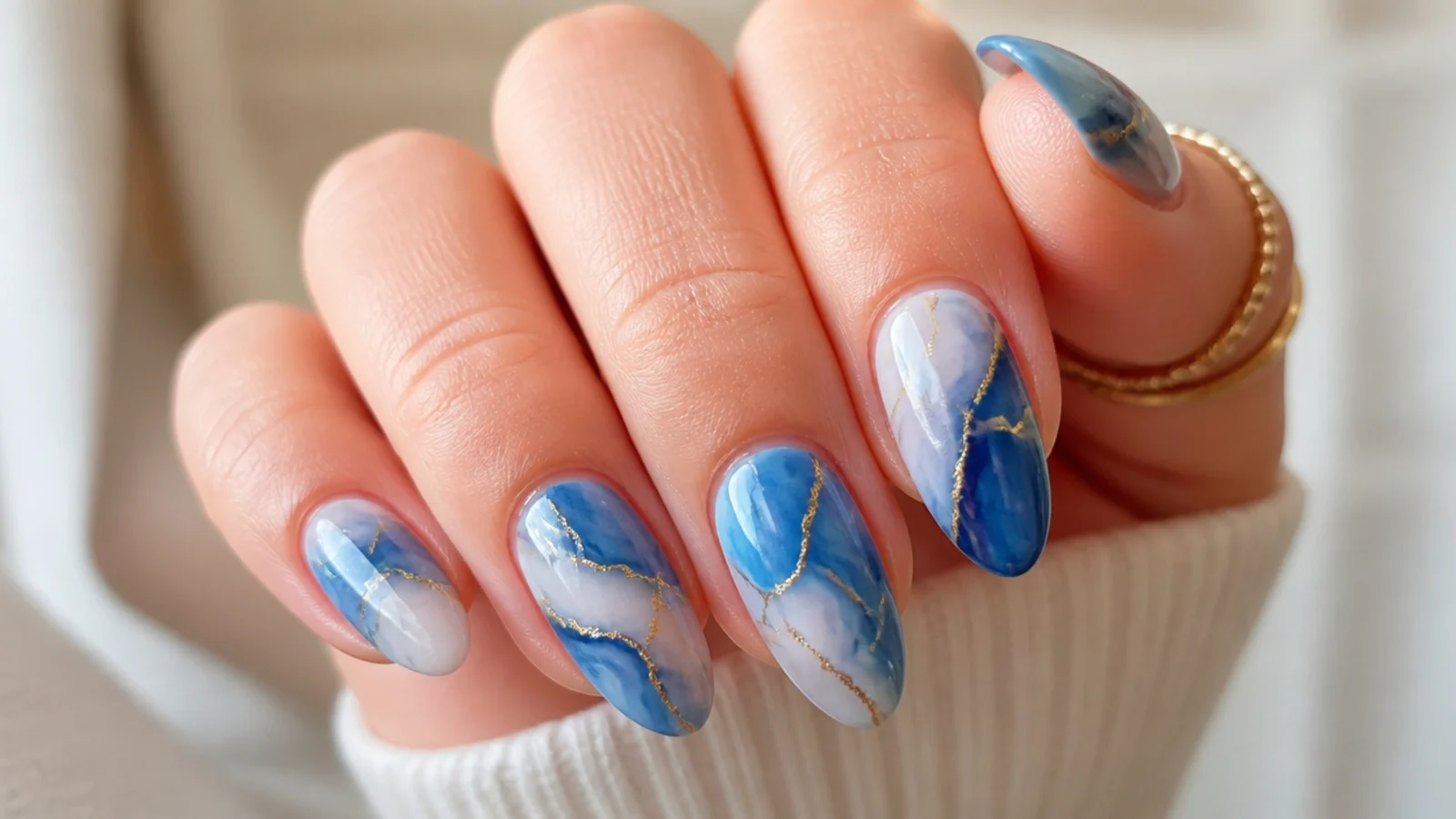 Royal blue and white marble swirl almond nails with veined detail